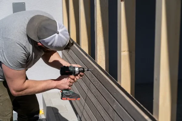 a-tough-construction-worker-applies-wooden-siding-2026-01-11-09-36-55-utc
